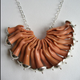 Image for article titled Who Would Wear Jewelry Made From Dismembered Barbie Dolls? (Slightly NSFW)